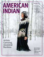 Magazine cover featuring a photograph of a person in a feathered ensemble standing in a snowy forest