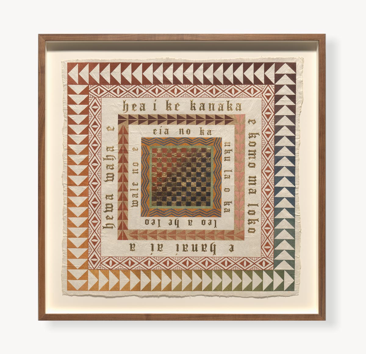 Framed art made of cloth pigmented in reddish tones and gold leaf.