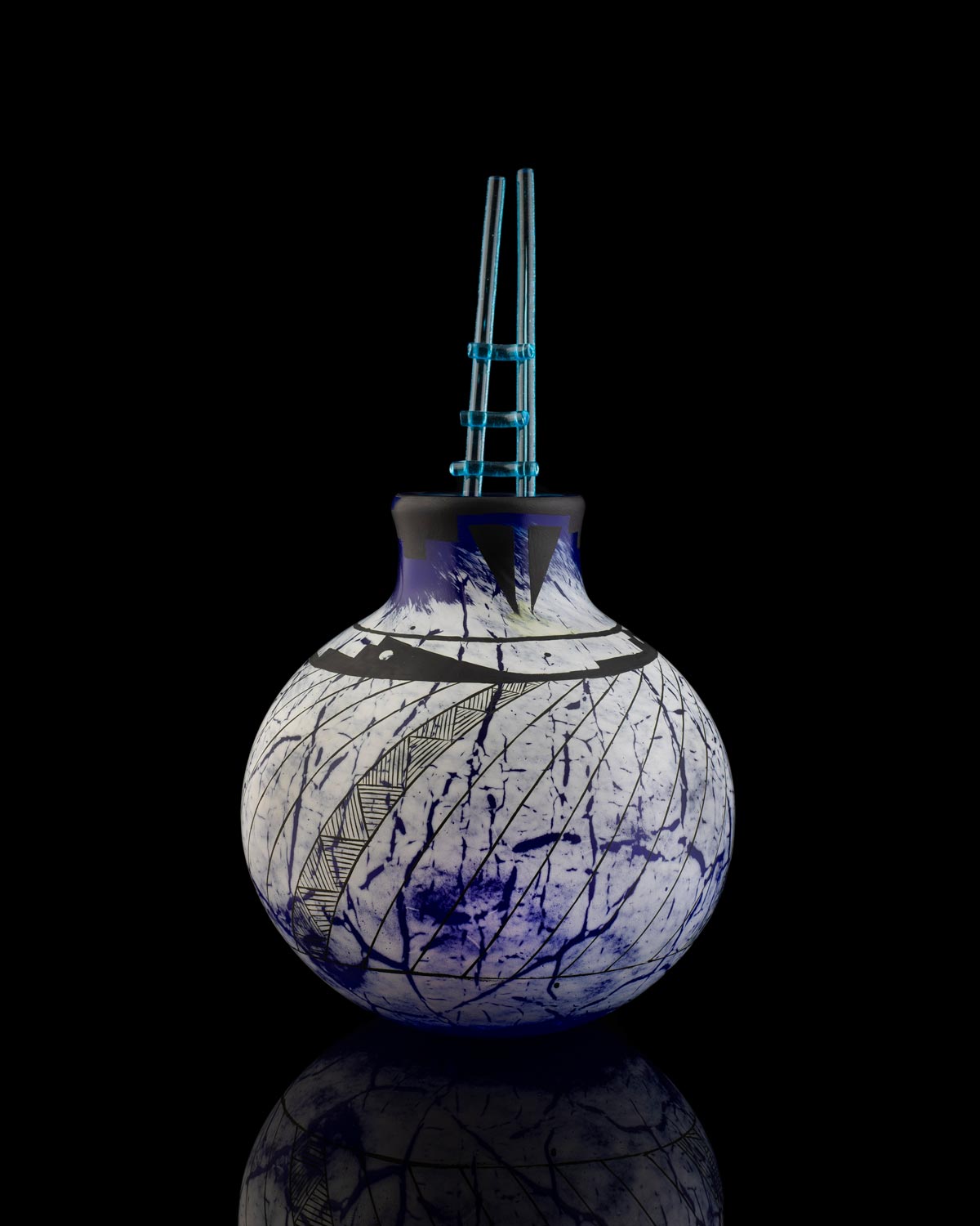 Blown and enameled blue and white glass white splatters of blue and intricate black etchings.