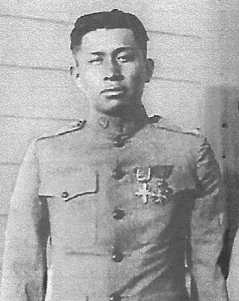 Calvvin Nahoto Atchavit wears a medal adorned military uniform in black and white photo.