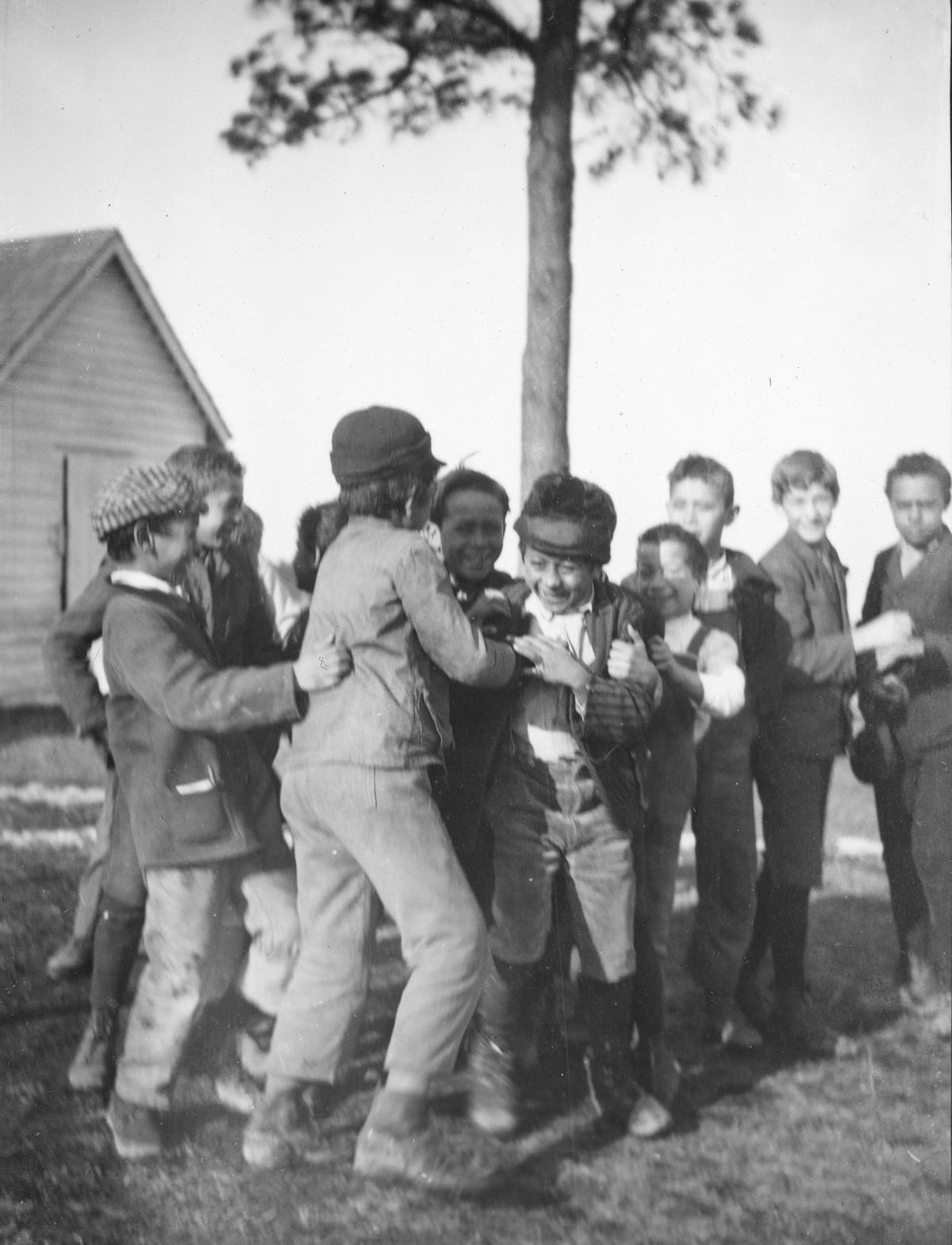 Group of children smiling and gathered in an embrace