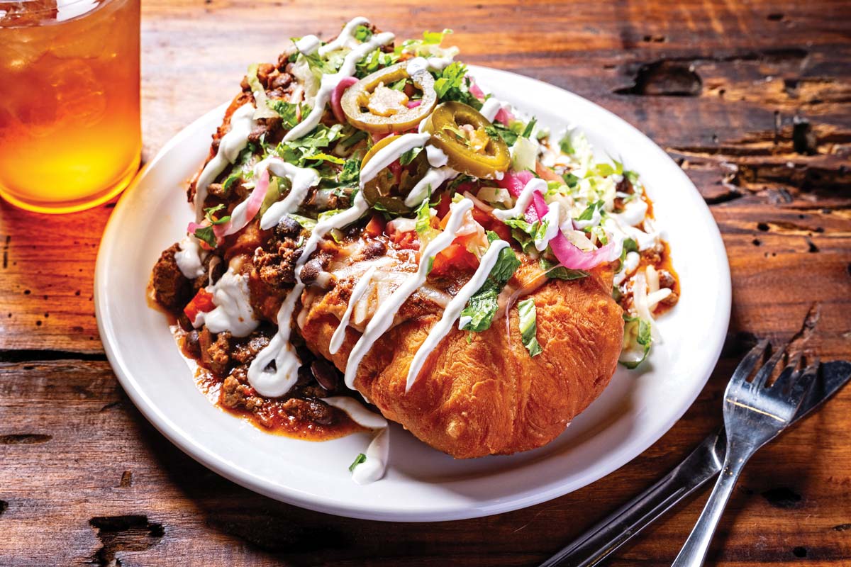 Indian taco with chili on top of frybread.