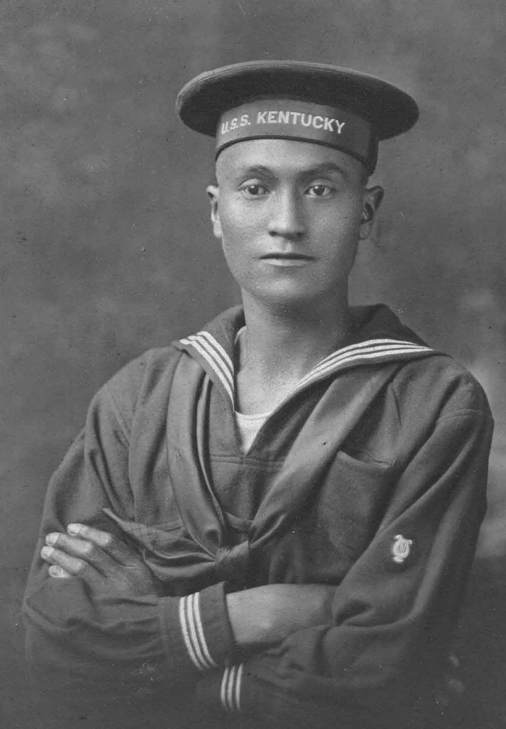 Isaac Sequajaw Willis wears a Navy uniform in a black and white studio portrait.