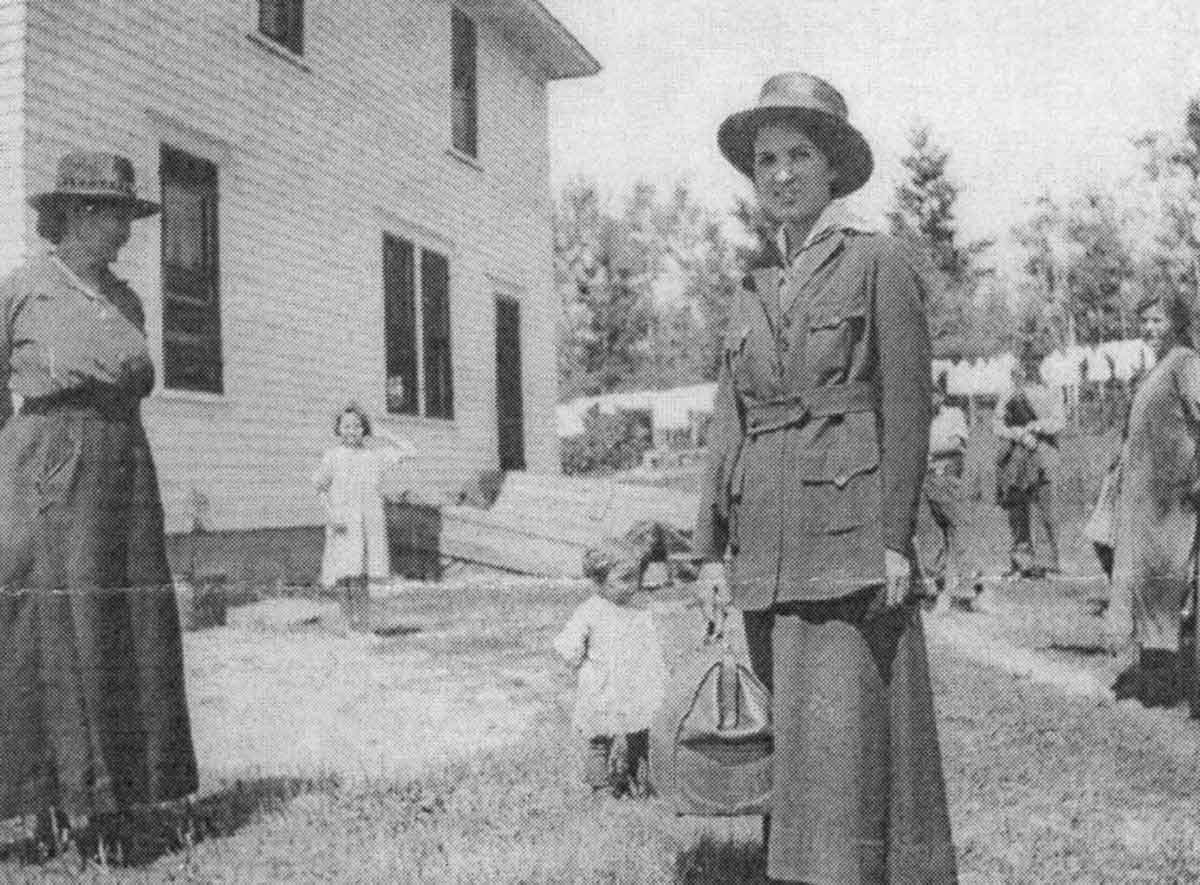 Ruth Cleveland Douglass Counihan in front of a house with small children.