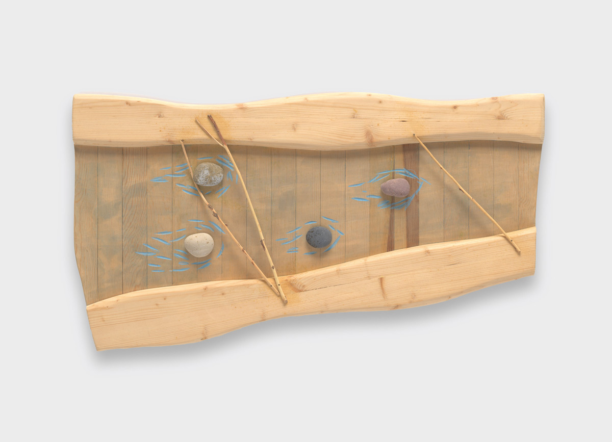 Wooden piece with small blue etchings, depicting a water's stream and banks.