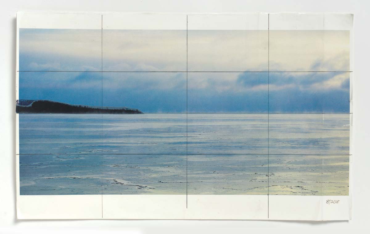 Composite photo of blue sky and water landscape scene with hand drawn grid overlaid.