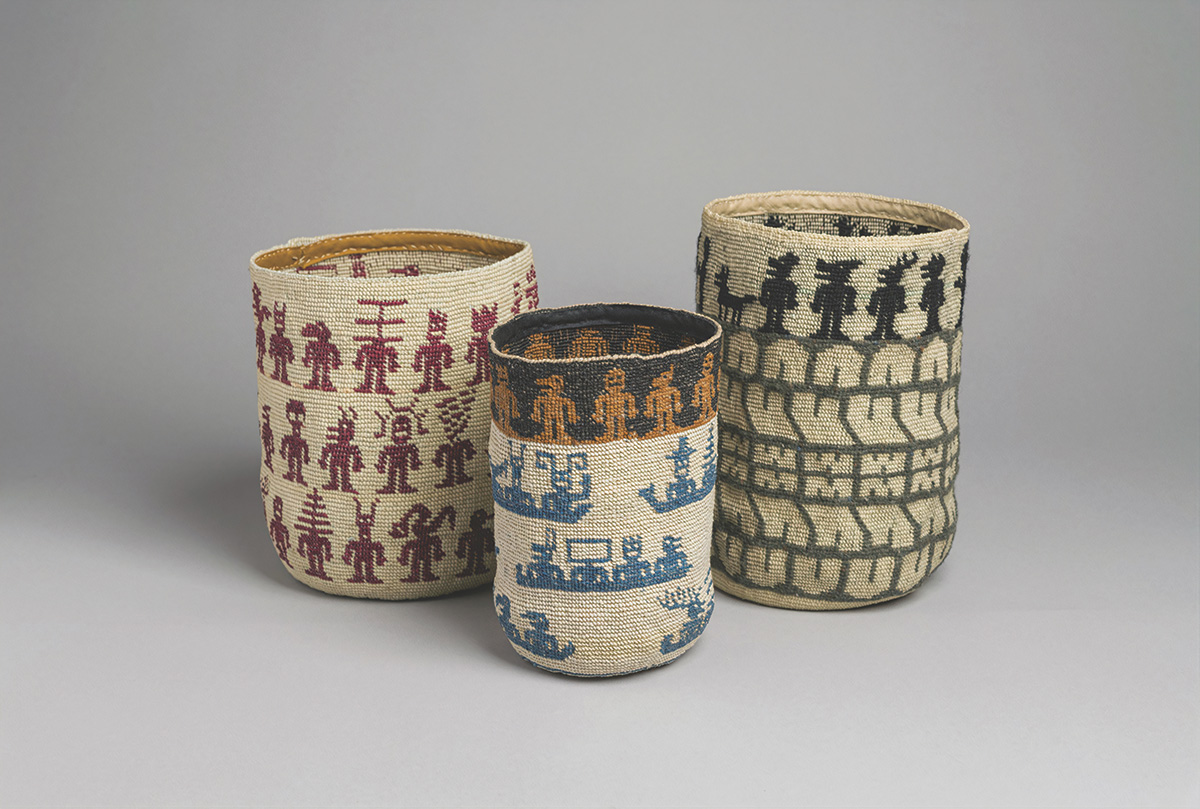 A photograph of three baskets decorated with characters and patterns