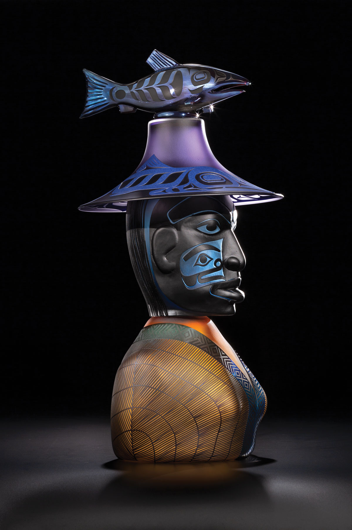 A bust of Salmon Woman, wearing a hat decorated with a salmon