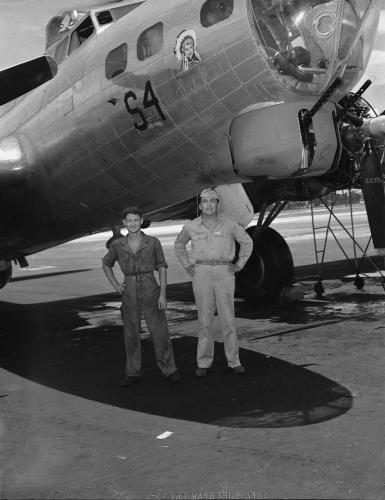 Horace Poolaw (Kiowa), on right. Unidentified figure on left. Artwork on the pla