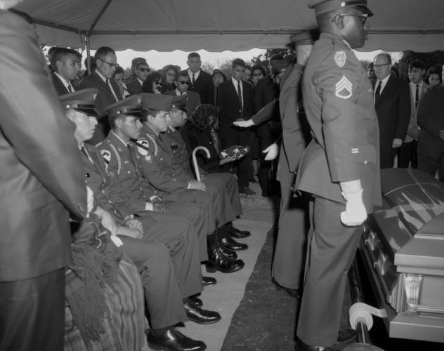 Irene Poolaw receives the flag at her husband Pascal Cleatus Poolaw, Sr.’s funer