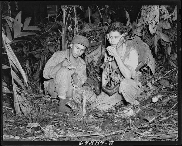 Diné [Navajo] code talkers kneeling in leaves