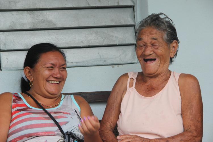 Idalis Ramírez shares a funny incident with great-aunt, Adela Romero Ramírez, while discussing traditional birthing stories, in the town of Palenque, Cuba.