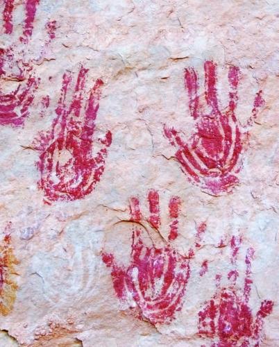 rock wall painting of handprints