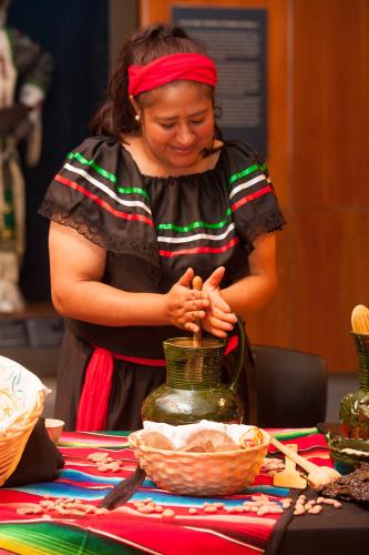 Woman grinding cacao beans