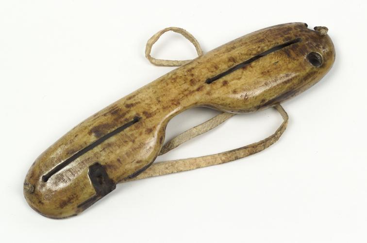 Carved ivory and hide snow goggles, probably Inupiaq, ca. 1890. Alaska. 23/5639