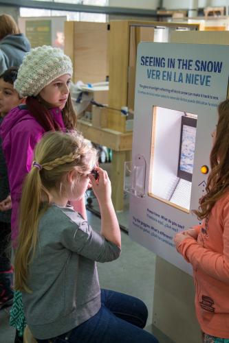 Students at snow goggle interactive station
