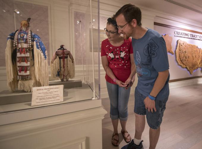 Visitors looking at handmade dolls 