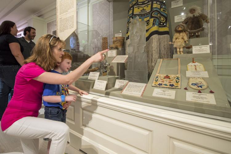 Mother with son looking at exhibit