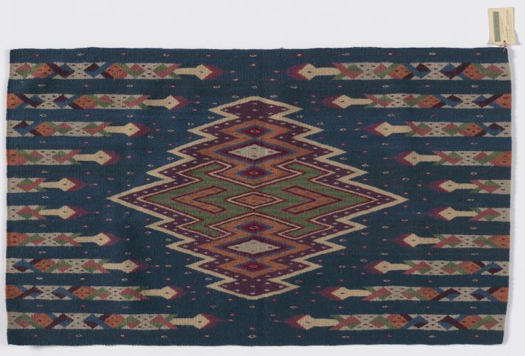 A wall hanging entitled Ofrenda by Porfirio Gutierrez, 53" x 32", acquired by NMAI in 2014 (26/9355).