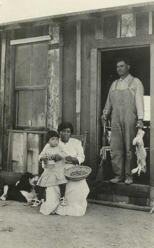 Tribal members sitting outside of Section 14 home