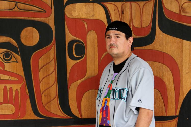 S'Klallam artist Jeffrey Veregge (standing in front of his Port Gamble tribe’s longhouse)