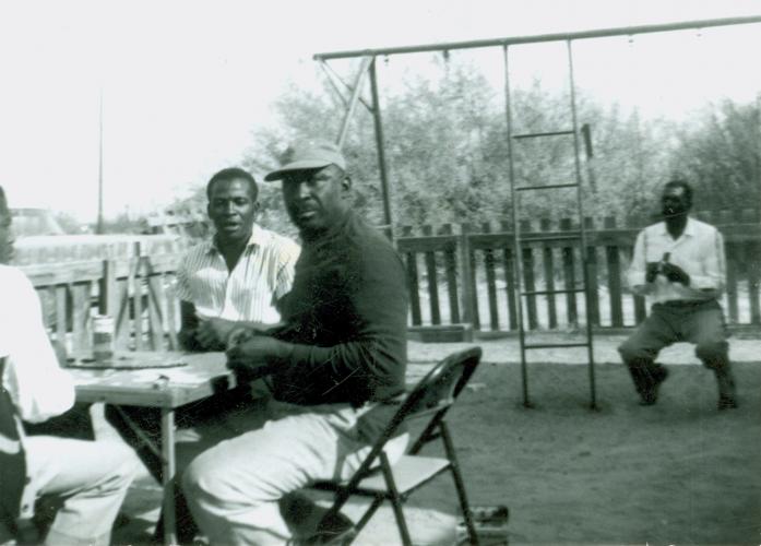 Black family sitting in yard in Palm Springs, California.