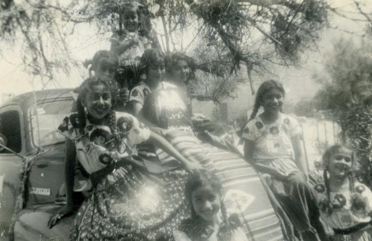 Mexican girls sitting on car in Palm Springs, California.