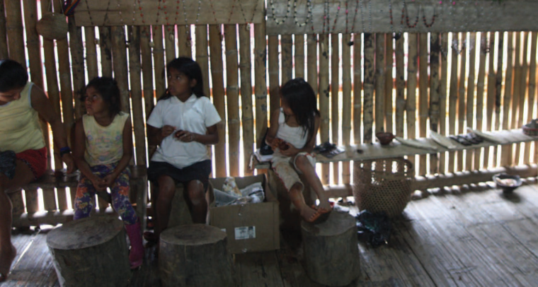Young girls work in the community’s gift shop selling items to tourists.