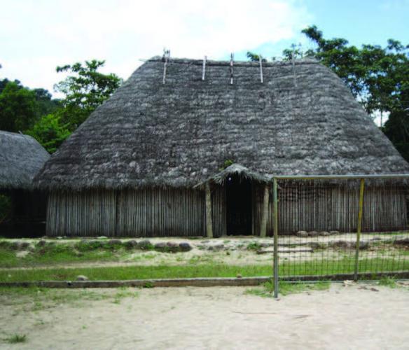 A traditional community building sits behind the village soccer field.