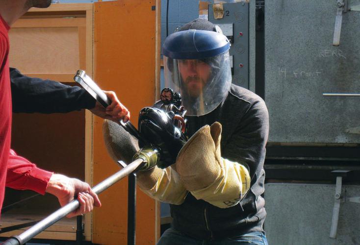 The hot rattle is removed from the blow pipe