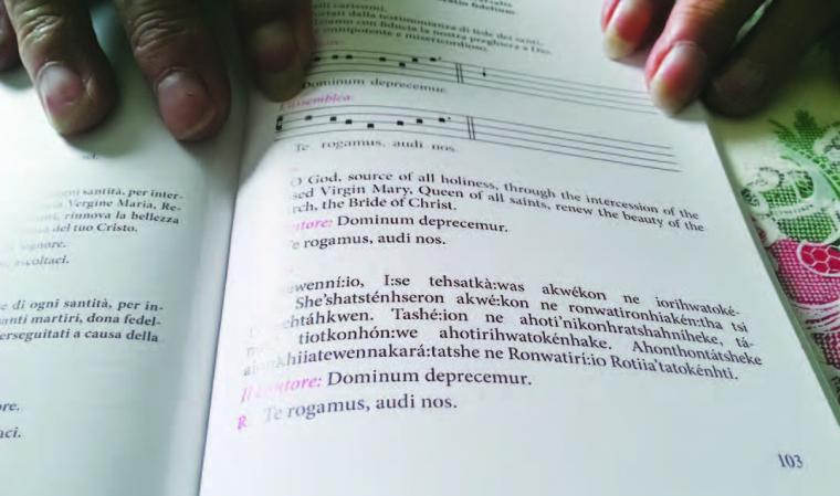 Louise Cook of Akwesasne displays the Mohawk verse of the Prayer of the Faithful