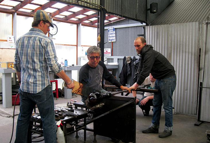 Singletary with his assistants forming the glass