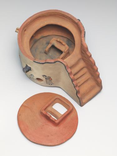 Cream ware kiva model with a hearth inside and a family painted on its walls