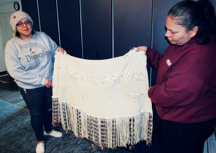 Michelle Hernandez-Wenzler (left) and Hazel James display the Granddaughter Dress