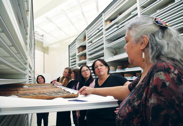 Dillard and the other basket makers examine an Ojibwe cedar bark mat