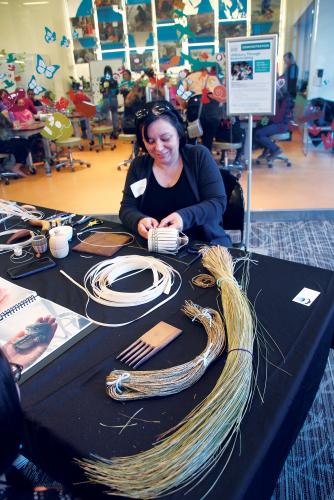 Neptune weaving sweetgrass into baskets