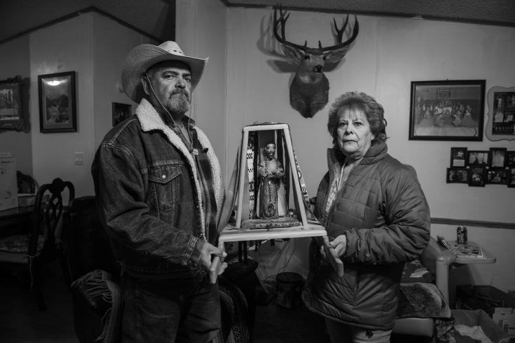 Frankie and Carmen López Holding Santo Tomás Bulto