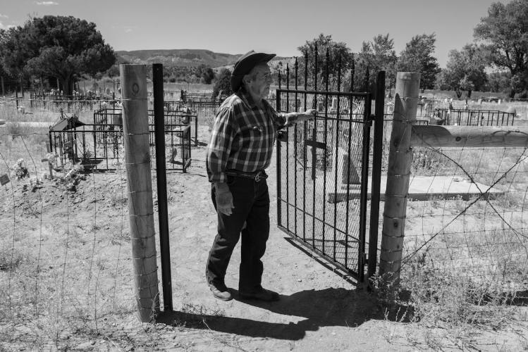 Johnny Jaramillo at the Gate of Abiquiú's Oldest Cemetery