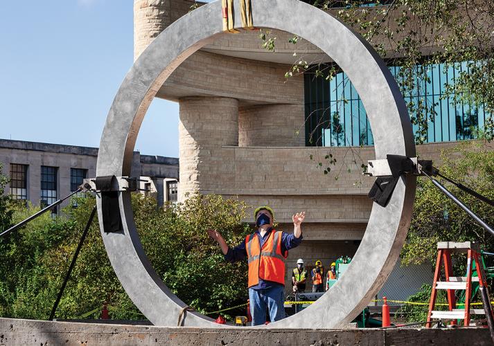 Henry Adams guides the centerpiece to the National Native American Veterans Memorial