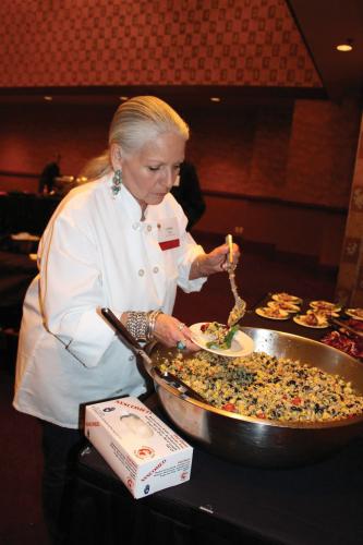 Loretta Oden spoons salad into a bowl