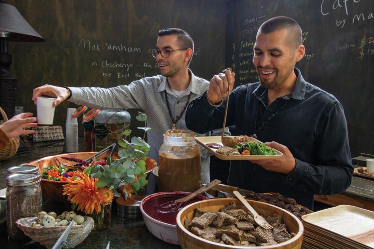 Vincent Medina and Louis Trevino plate food and serve customers at their cafe