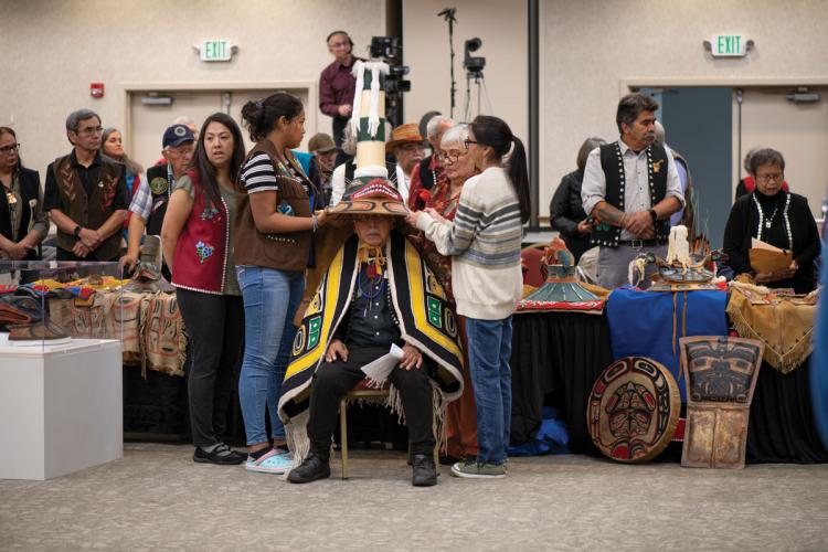 Members of the Dakl'aweidí clan placing the new Sculpin Hat upon Kiks.ádi leader Ray Wilson Sr. at a ceremony