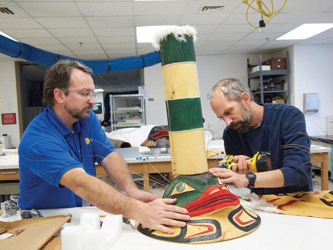 Eric Hollinger and Chris Hollshwander attaching sea lion whiskers to the new Sculpin Hat