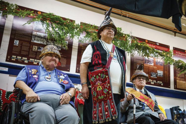 Three Tlingit veterans wearing battle helmets