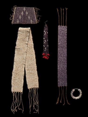 Purple and white wampum beads are used to make objects such as these belts, strings, cuff ornament and bracelet 