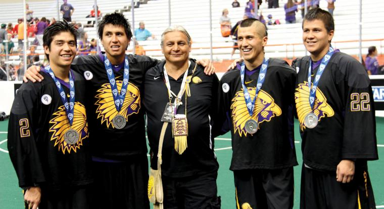 Miles Thompson, Lyle Thompson, Jeremy Thompson, and Haina Thompson standing with Tracy Shenandoah, wearing silver metals