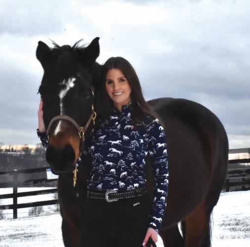 Monica Buckle (Cherokee) standing with a horse at the Pegasus Therapeutic Riding school in Brewster, New York.