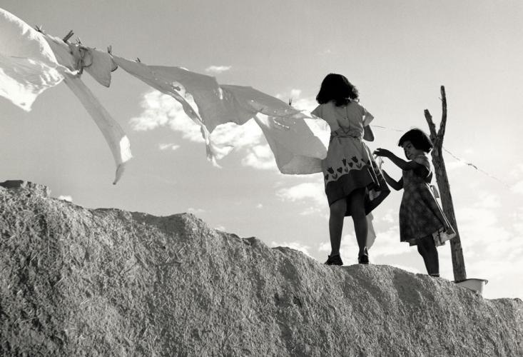 Two girls hanging clothes on a clothesline