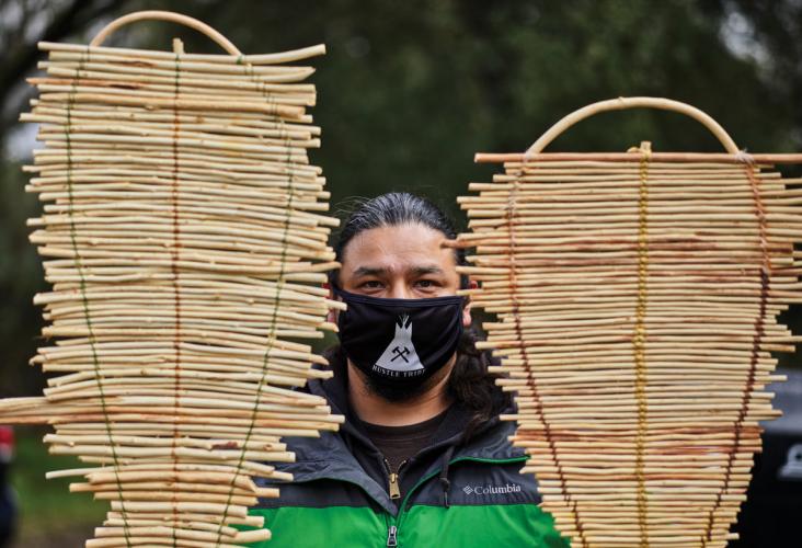 Danny Manning holds two cradleboards