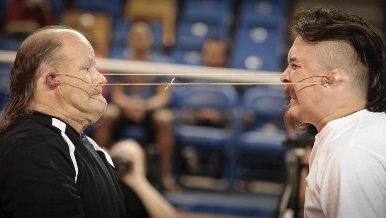 Linc Qimiq and Leroy Shangin engage in a tug-of-war using sinew looped around one of each other's ears